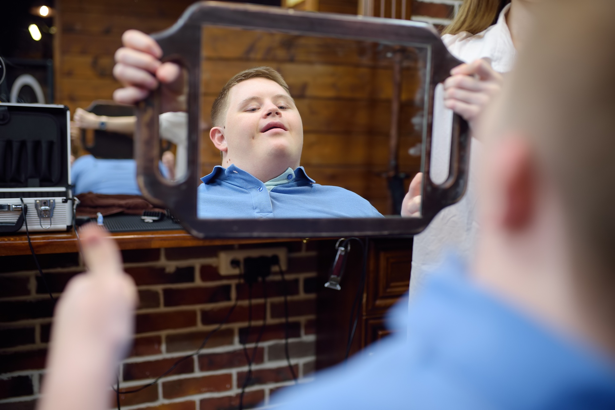 Portrait of a teenager with Down syndrome in a barbershop